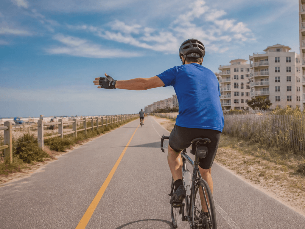Bike left-turn hand signals on Coastal Highway edges — supporting Beach Blog photo, Ocean City, Maryland