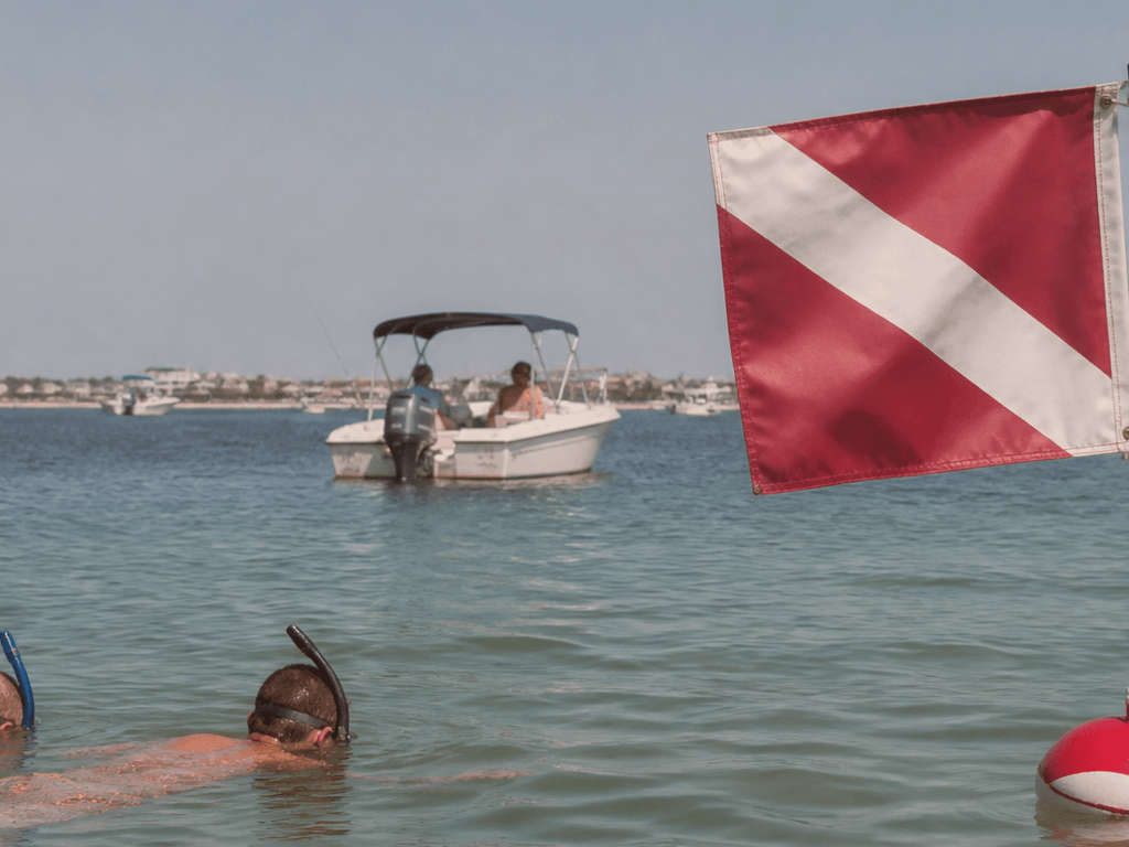 Close-up of a red-and-white diver-down flag rigged on a bay boat near Ocean City Maryland