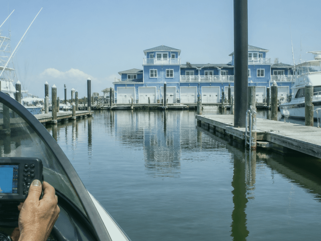 Finger dropping a waypoint on a marine chartplotter at an Ocean City Maryland marina