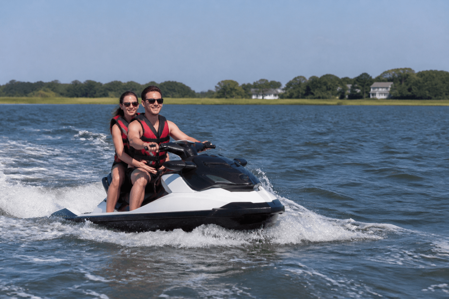 Two-up jet ski on calm bay water with capacity label visible on the stern near Ocean City Maryland