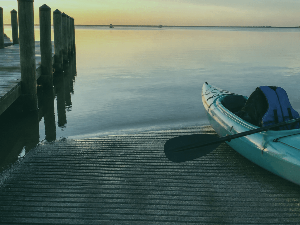 Close-up of hands adjusting a kayak life jacket before launch on the Ocean City bay side