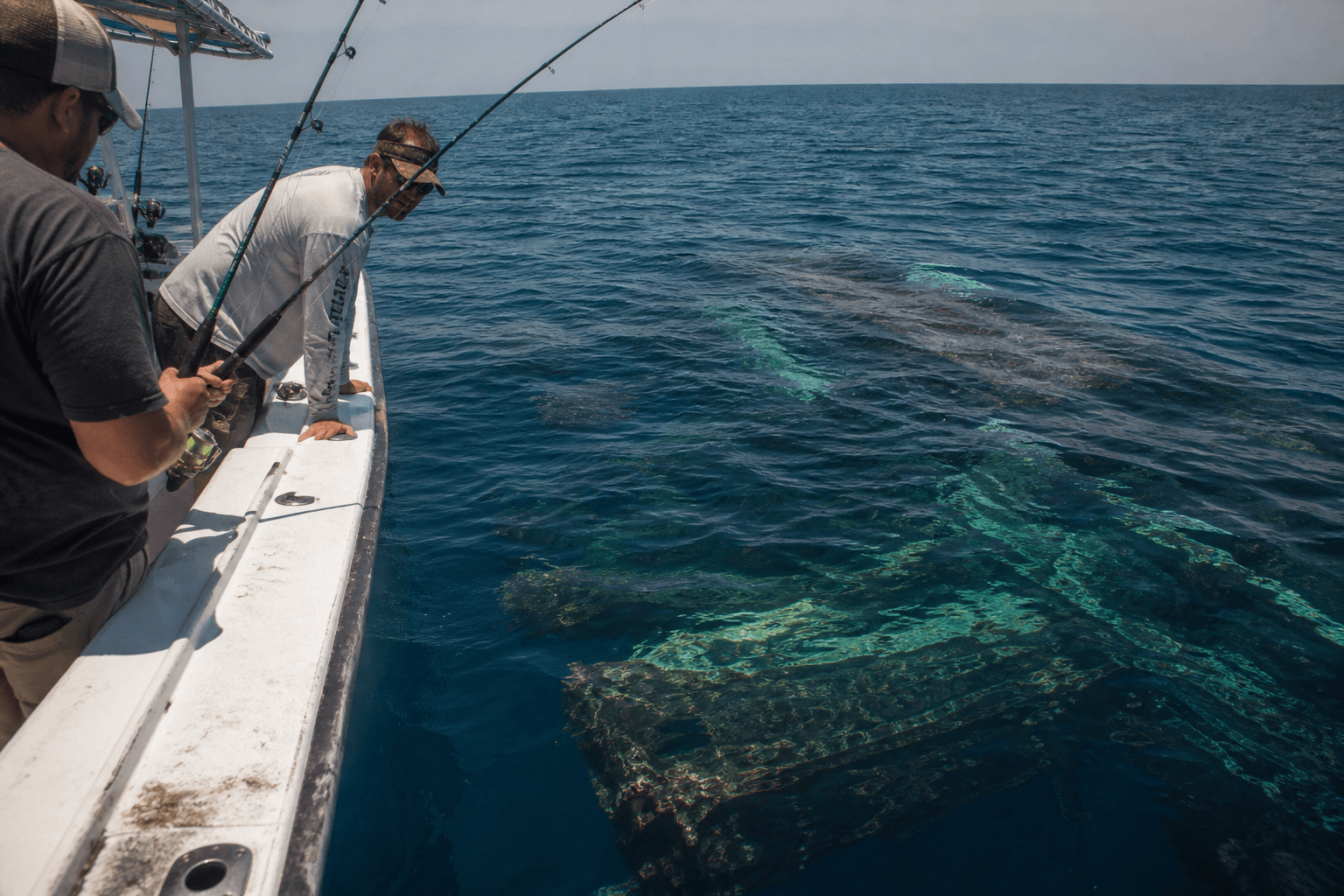 Head boat anglers offshore near Ocean City with shark circling in choppy blue water