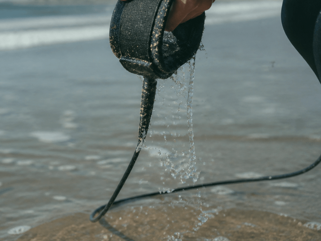 Surf leash cuff: rinse sand or wear a rash — supporting Beach Blog photo, Ocean City, Maryland