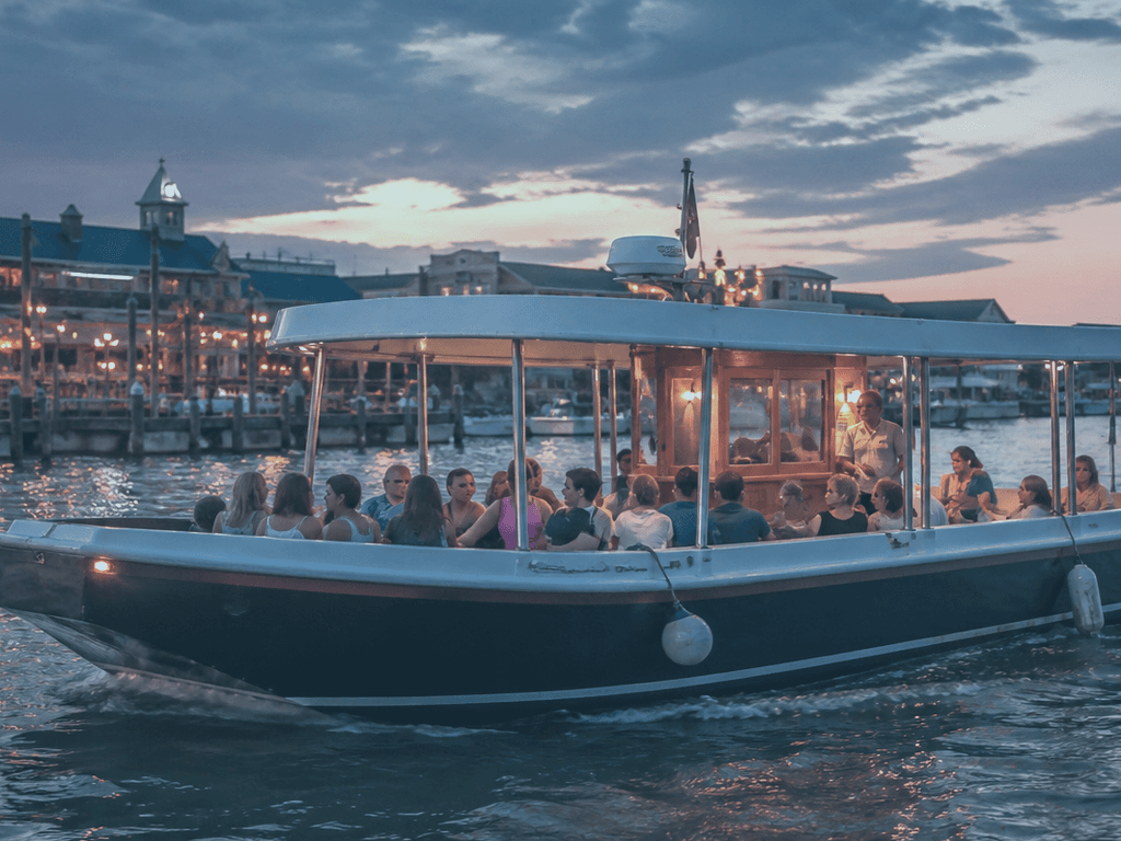 Printed water taxi schedule beside a phone showing dock times for an Ocean City evening trip