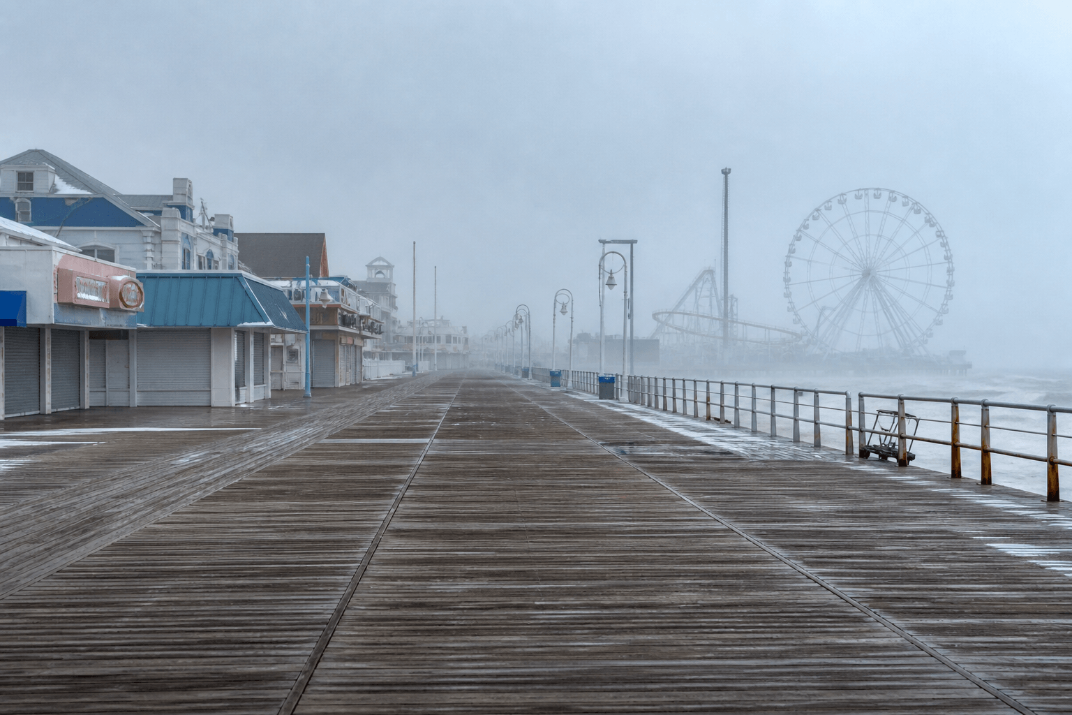 Winter Boardwalk in Ocean City Maryland: empty wooden planks, soft gray light, and quiet ocean edge — Beach Blog photo